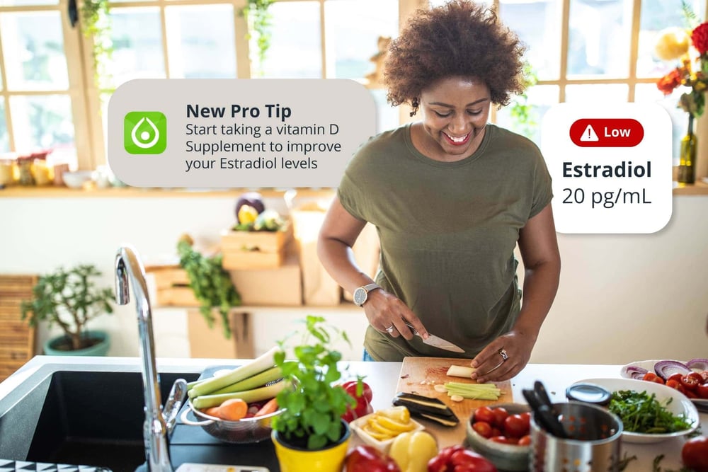 A black woman chopping vegetables on a kitchen counter