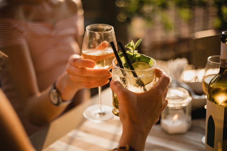 Two women holding mock-tails 