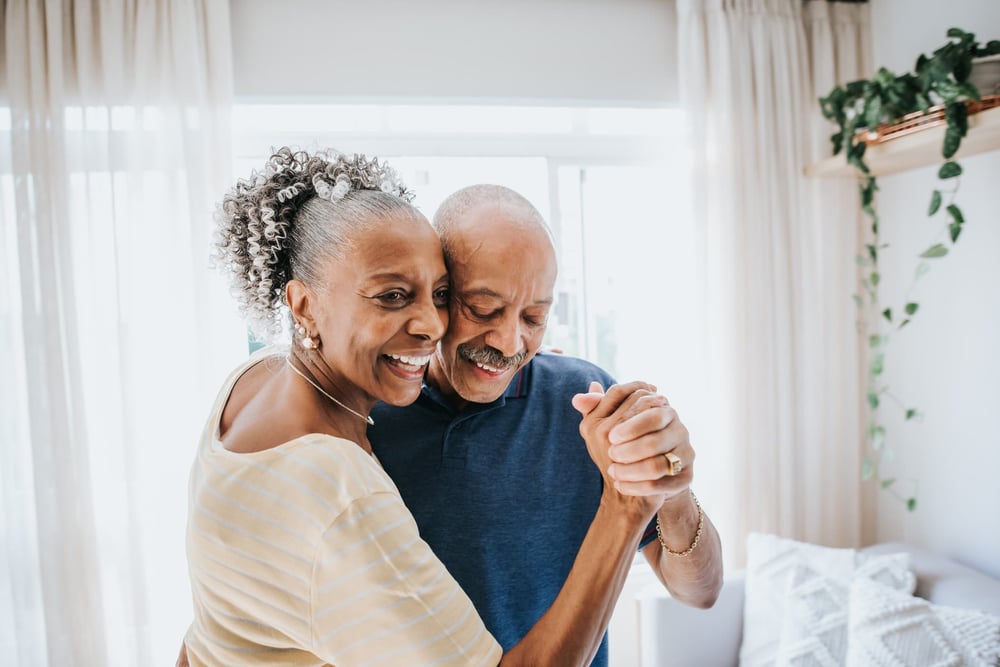 Senior couple dancing in living room