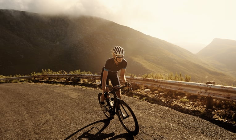 Person riding a bicycle up a hill