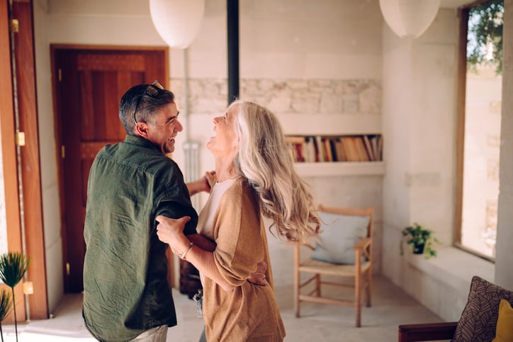 Older couple dancing in a living room