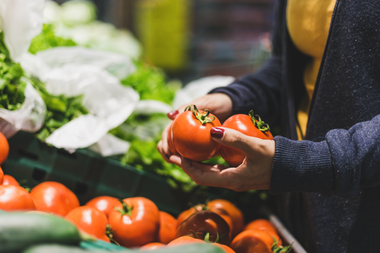 Woman shopping for tomatoes