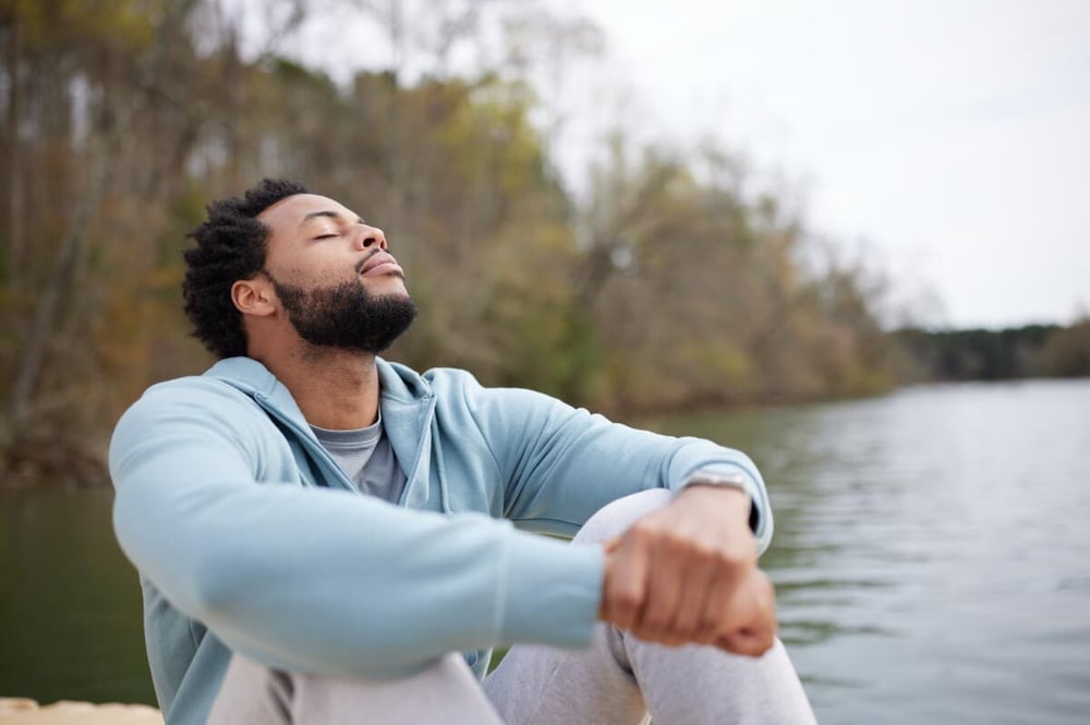 Man sitting on a dock soaking up the sun