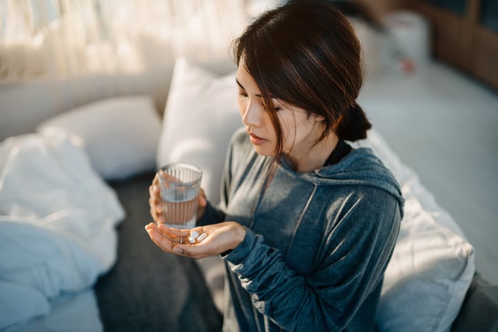 Woman taking vitamin d supplement