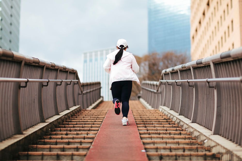 woman running weight loss plateau