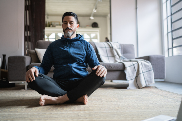 man sitting in yoga pose